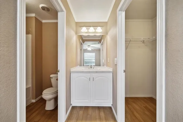 a bathroom with a granite countertop toilet a sink and a mirror