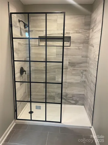 a bathroom with a glass shower door