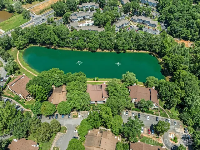 an aerial view of a house with a yard and lake view