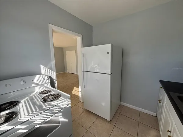 a kitchen with a refrigerator and a stove