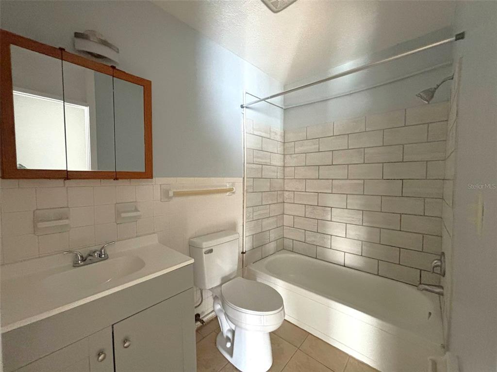 310 Farnol Street Southwest, Unit 3 Winter Haven, FL 33880 - Photo 8 of 9 a bathroom with a sink a toilet and shower