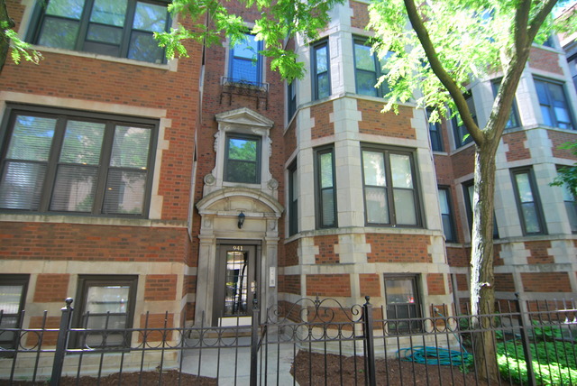 941 West Gordon Terrace, Unit 1E Chicago, IL 60613 - Photo 1 of 14 a view of a brick building next to a large tree