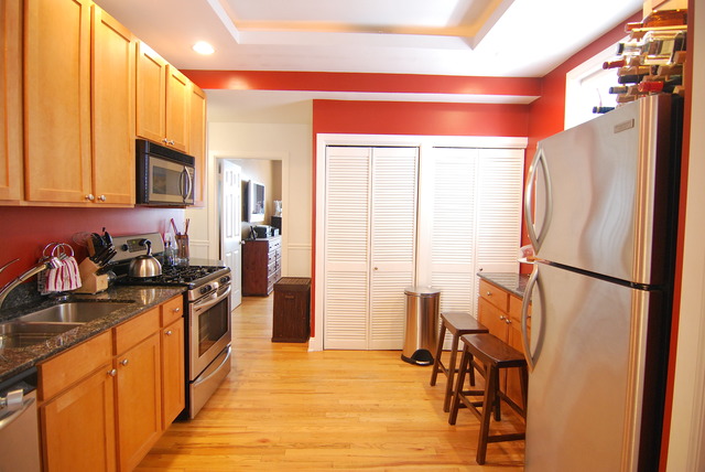 941 West Gordon Terrace, Unit 1E Chicago, IL 60613 - Photo 13 of 14 a kitchen with stainless steel appliances granite countertop a refrigerator and a stove top oven
