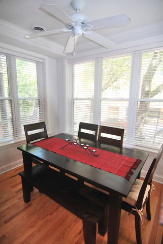 941 West Gordon Terrace, Unit 1E Chicago, IL 60613 - Photo 6 of 14 a room with a bed and a table