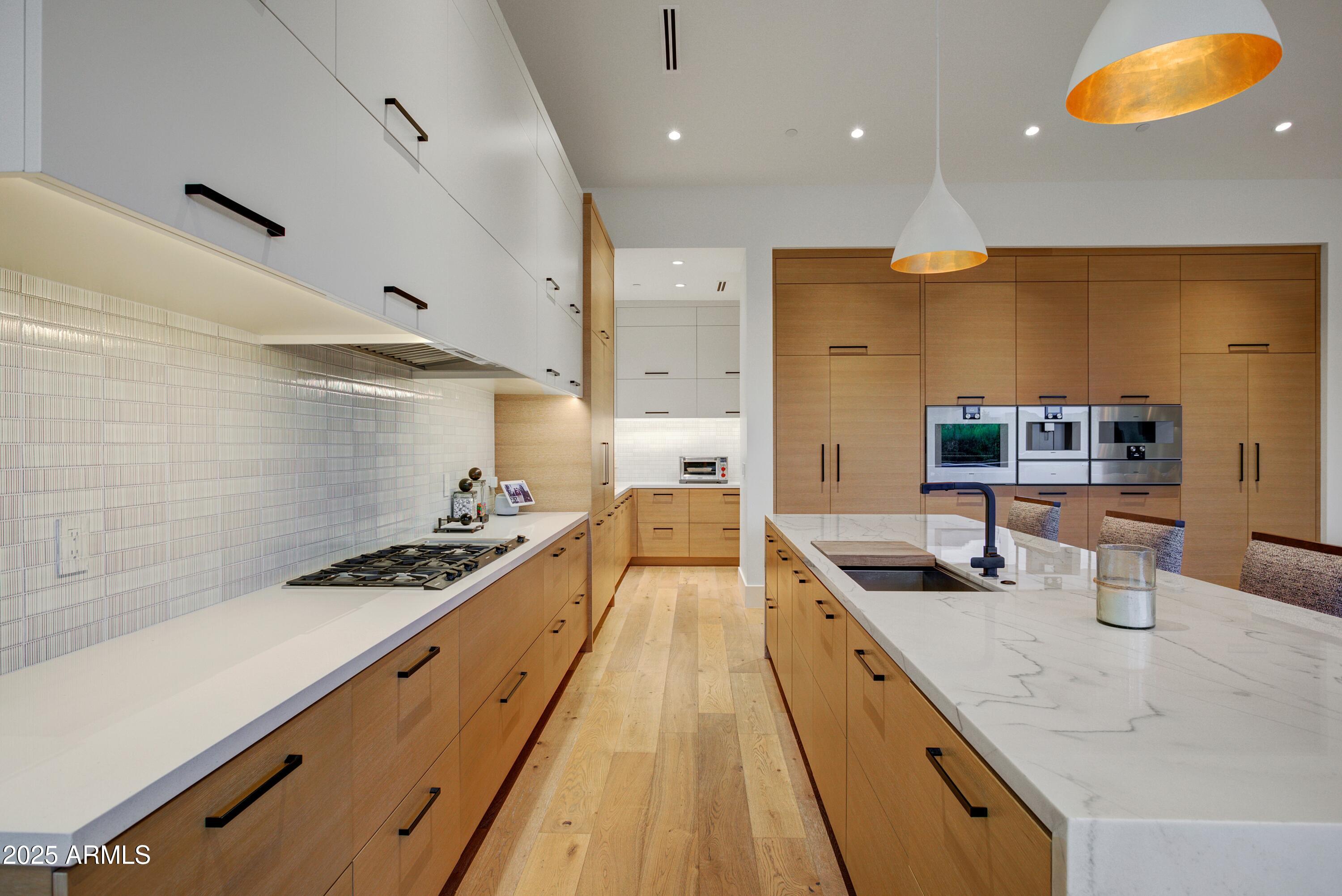 6930 East Cactus Wren Road Paradise Valley, AZ 85253 - Photo 11 of 26 a kitchen with stainless steel appliances granite countertop a stove a sink and a refrigerator
