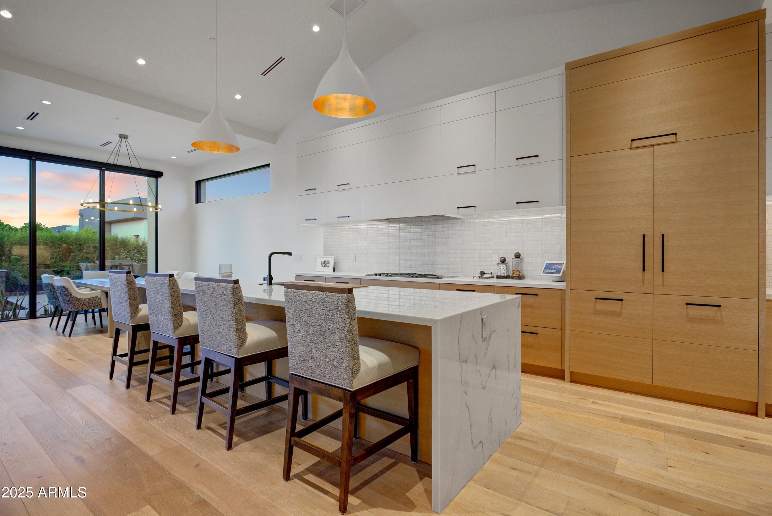 6930 East Cactus Wren Road Paradise Valley, AZ 85253 - Photo 12 of 26 a kitchen with a table chairs sink and cabinets