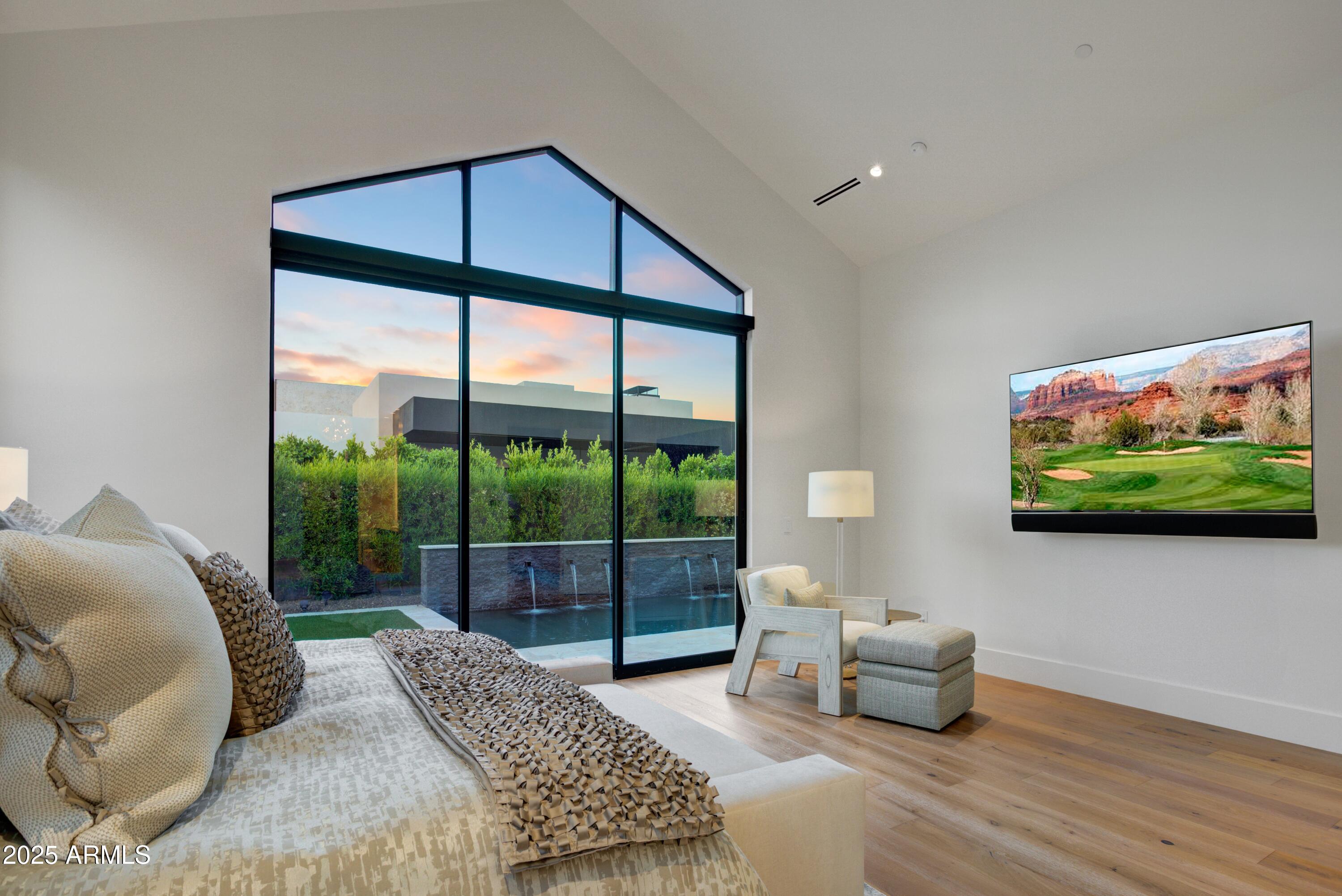 6930 East Cactus Wren Road Paradise Valley, AZ 85253 - Photo 15 of 26 a living room with furniture tv and a floor to ceiling window