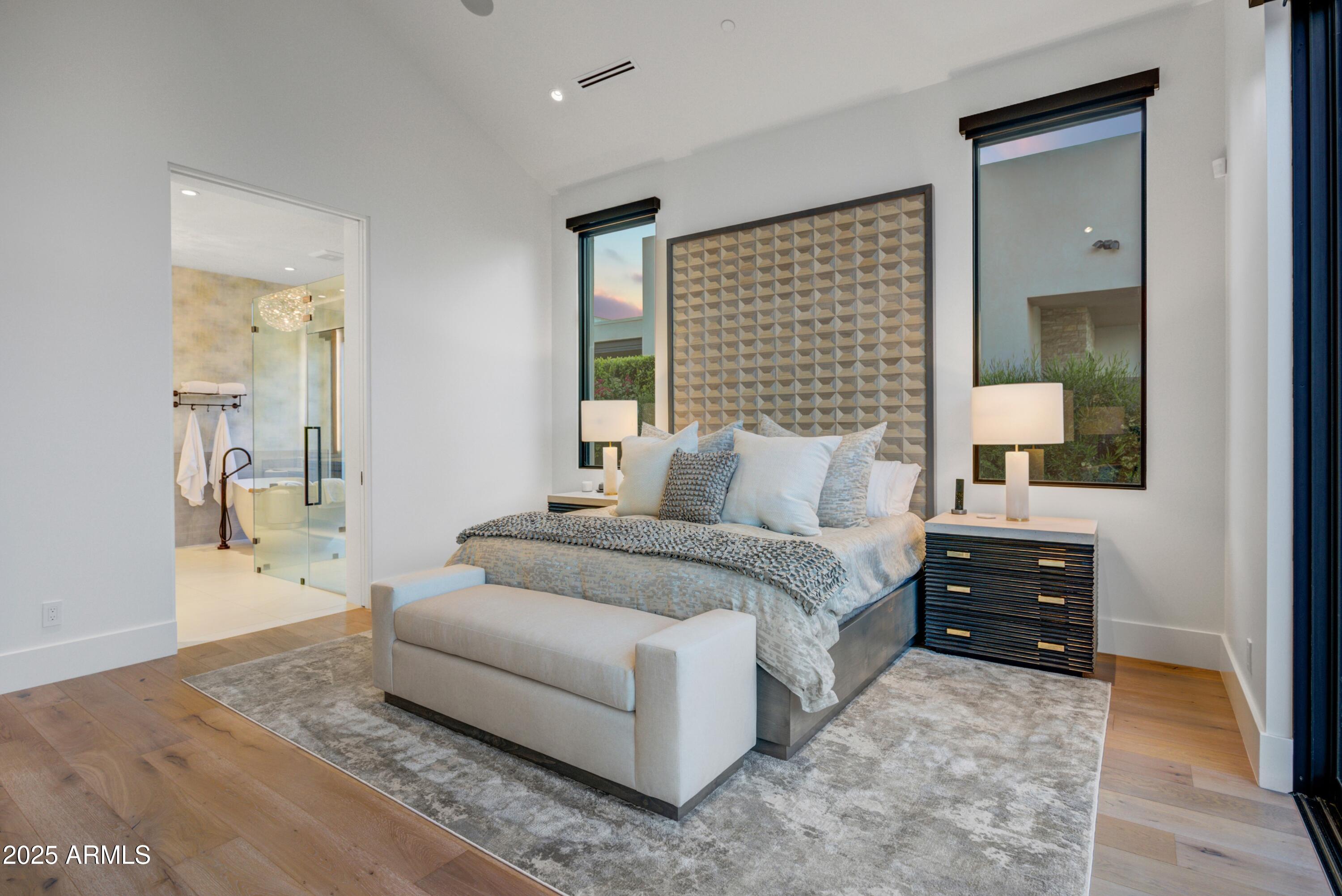 6930 East Cactus Wren Road Paradise Valley, AZ 85253 - Photo 16 of 26 a bedroom with a bed and a cabinets