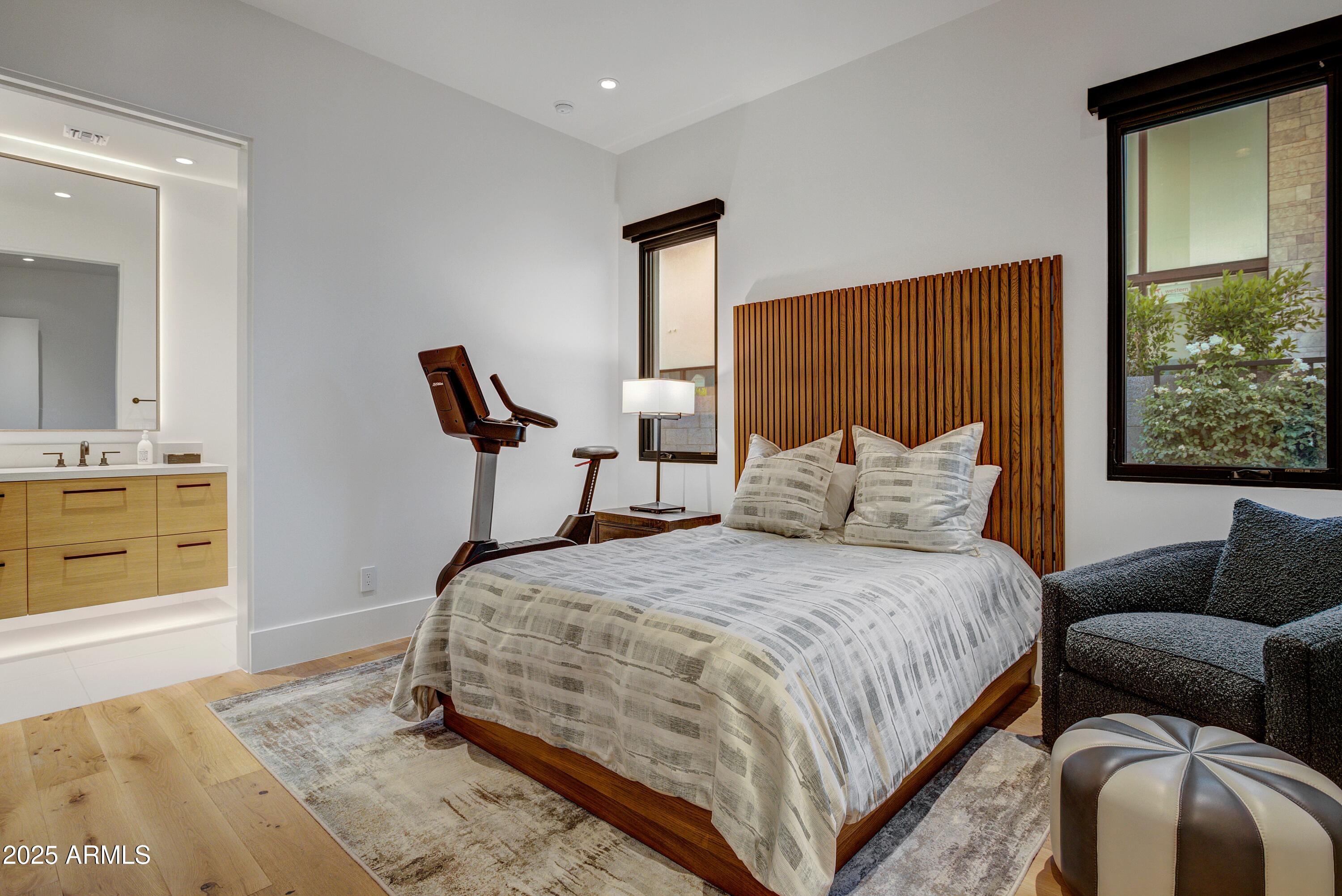 6930 East Cactus Wren Road Paradise Valley, AZ 85253 - Photo 19 of 26 a bedroom with a bed and window