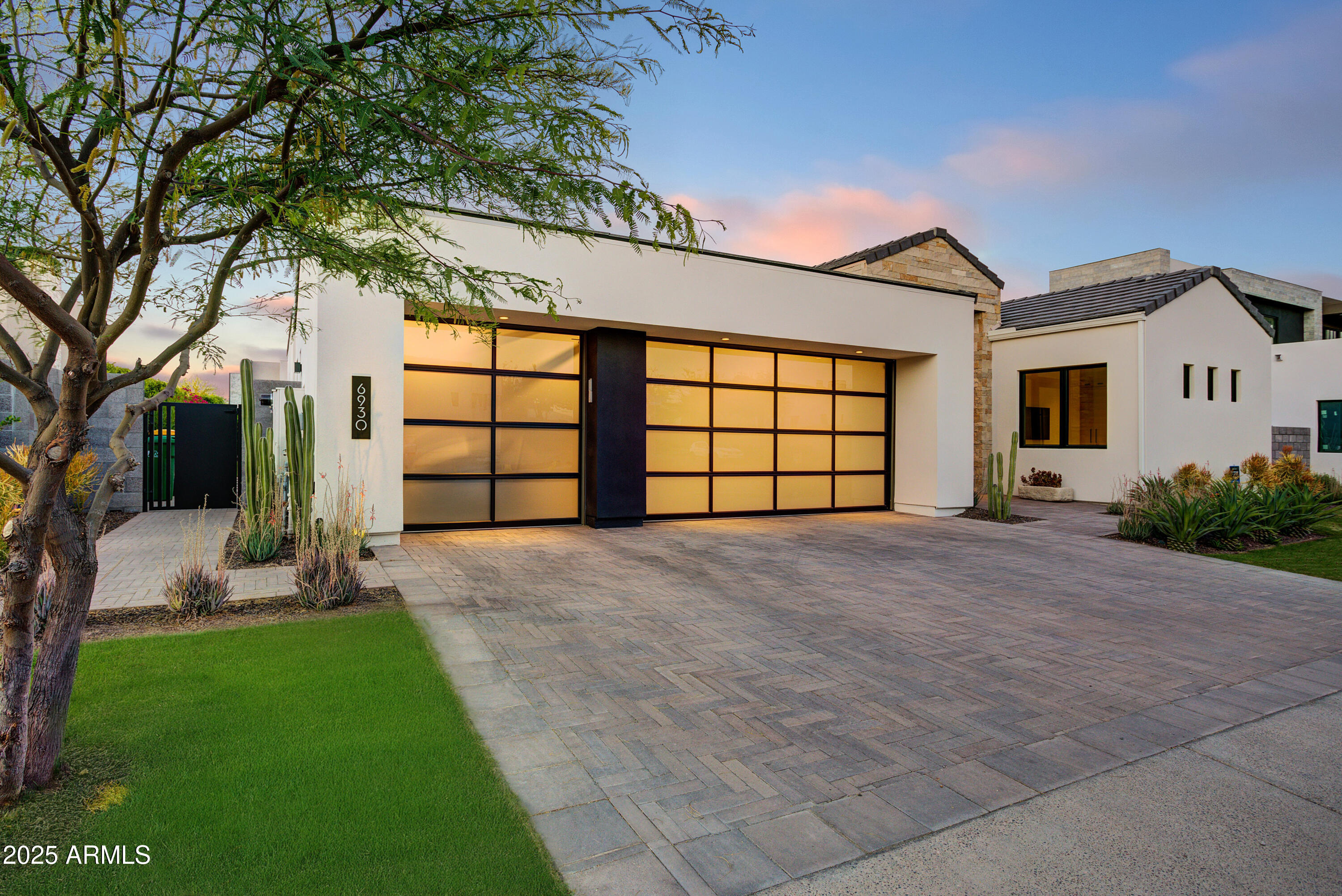 6930 East Cactus Wren Road Paradise Valley, AZ 85253 - Photo 2 of 26 a front view of a house with a yard and garage