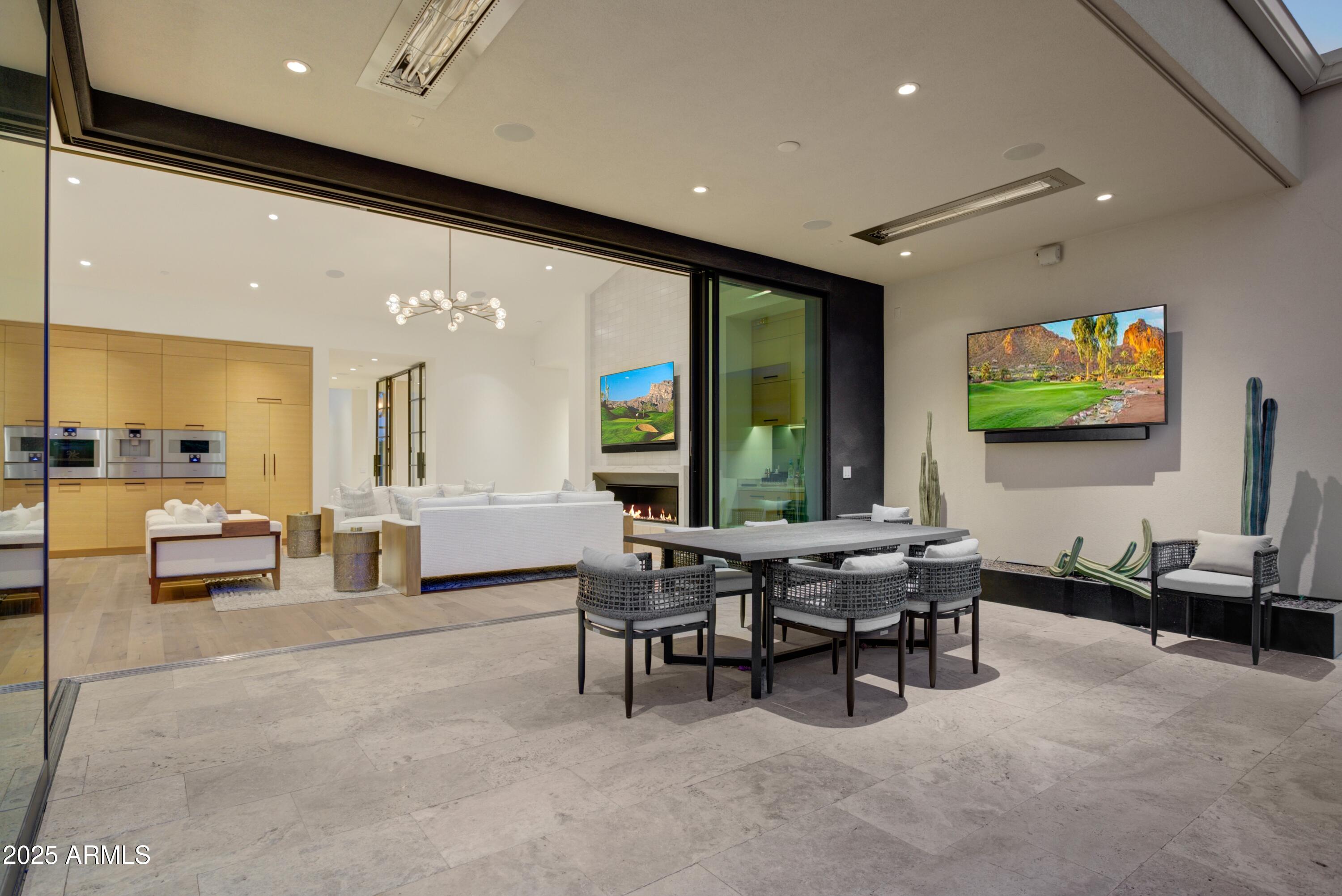 6930 East Cactus Wren Road Paradise Valley, AZ 85253 - Photo 22 of 26 a living room with furniture and a flat screen tv
