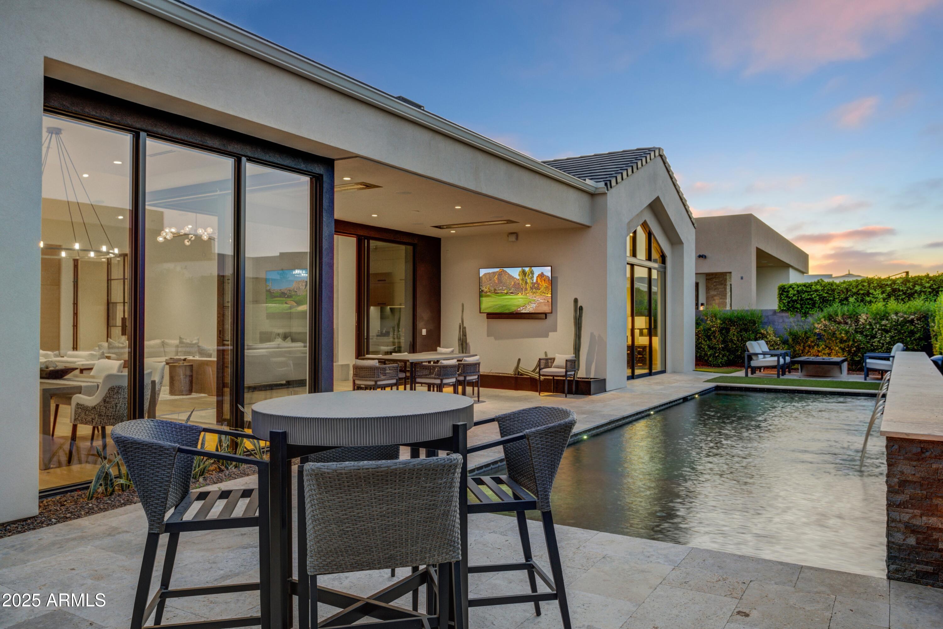 6930 East Cactus Wren Road Paradise Valley, AZ 85253 - Photo 24 of 26 a view of a dining room with furniture window and wooden floor