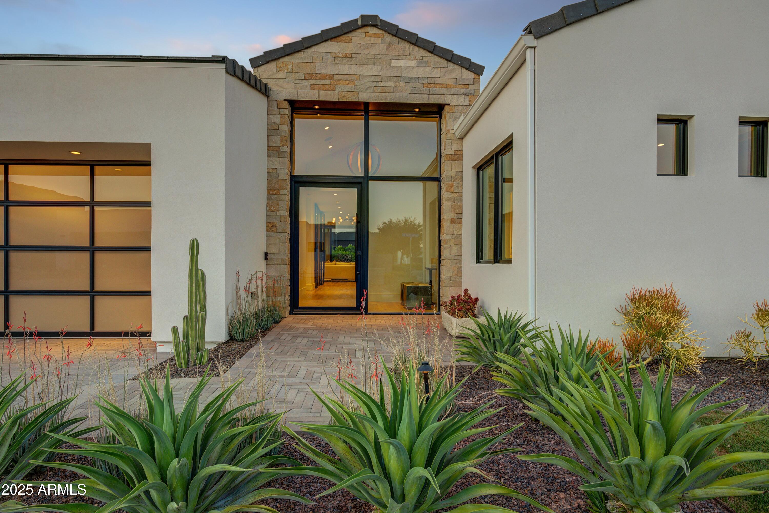6930 East Cactus Wren Road Paradise Valley, AZ 85253 - Photo 3 of 26 a house with a plant in front of it