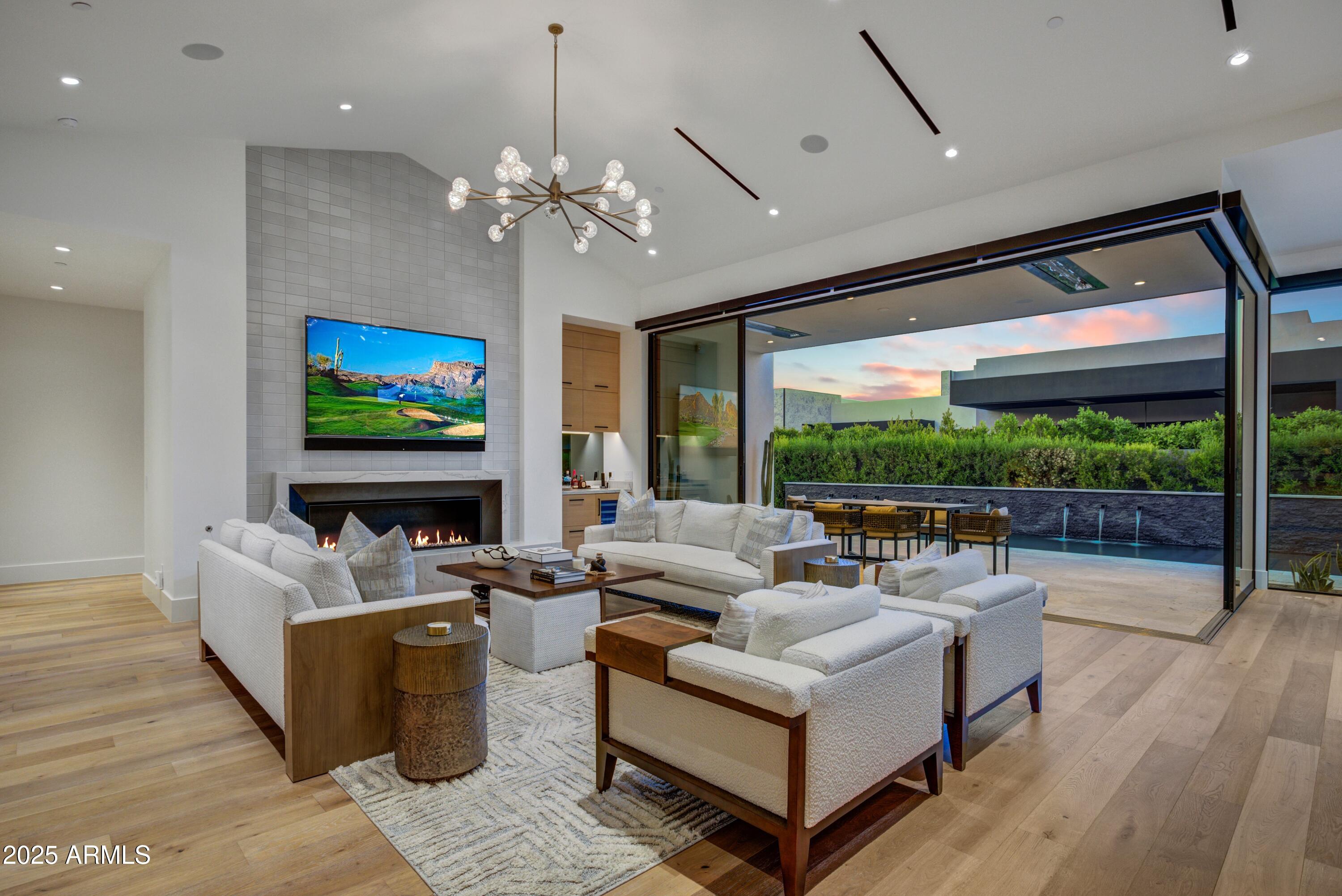 6930 East Cactus Wren Road Paradise Valley, AZ 85253 - Photo 5 of 26 a living room with fireplace furniture and a flat screen tv