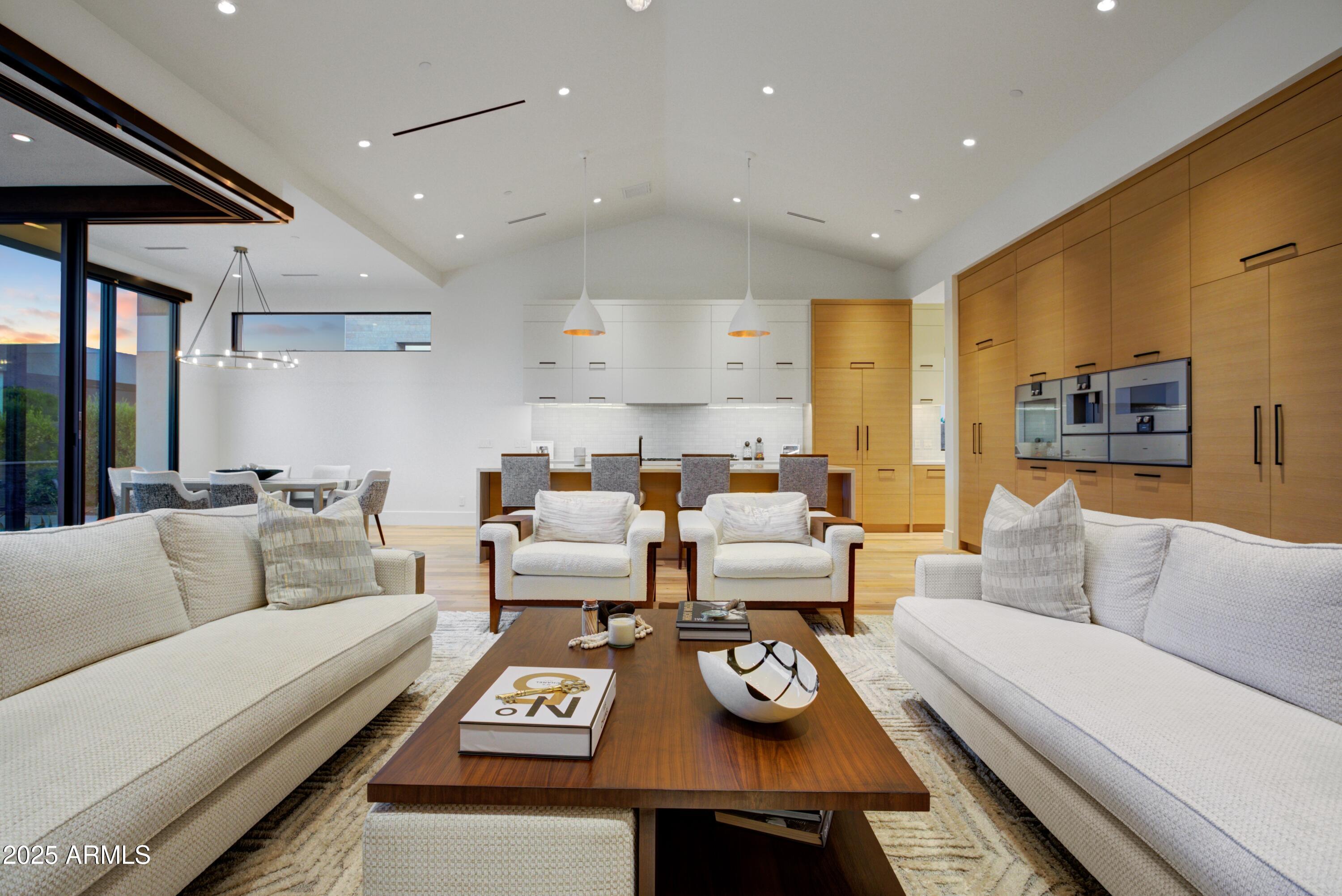 6930 East Cactus Wren Road Paradise Valley, AZ 85253 - Photo 9 of 26 a living room with furniture couches and kitchen view