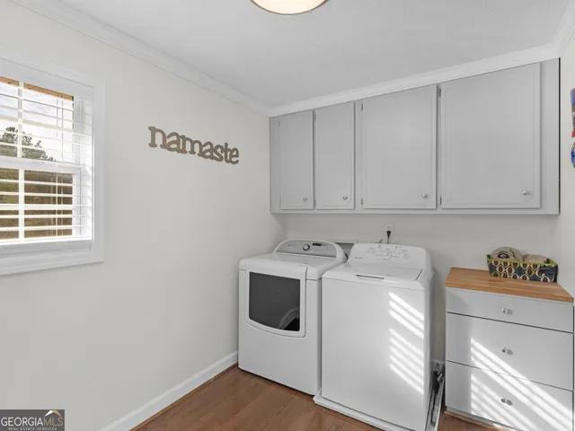 a view of a big house with a big yard and large tree