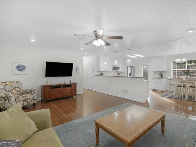 a living room with furniture and a flat screen tv