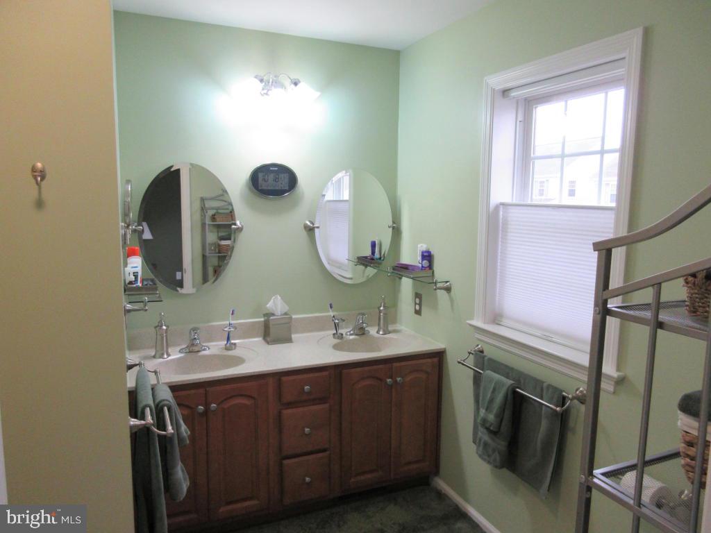 760 Wallingford Road Lititz, PA 17543 - Photo 9 of 16 a bathroom with a double vanity sink and a mirror