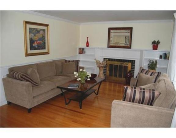 27 Cherokee Road Arlington, MA 02474 - Photo 3 of 19 a living room with furniture and a fireplace