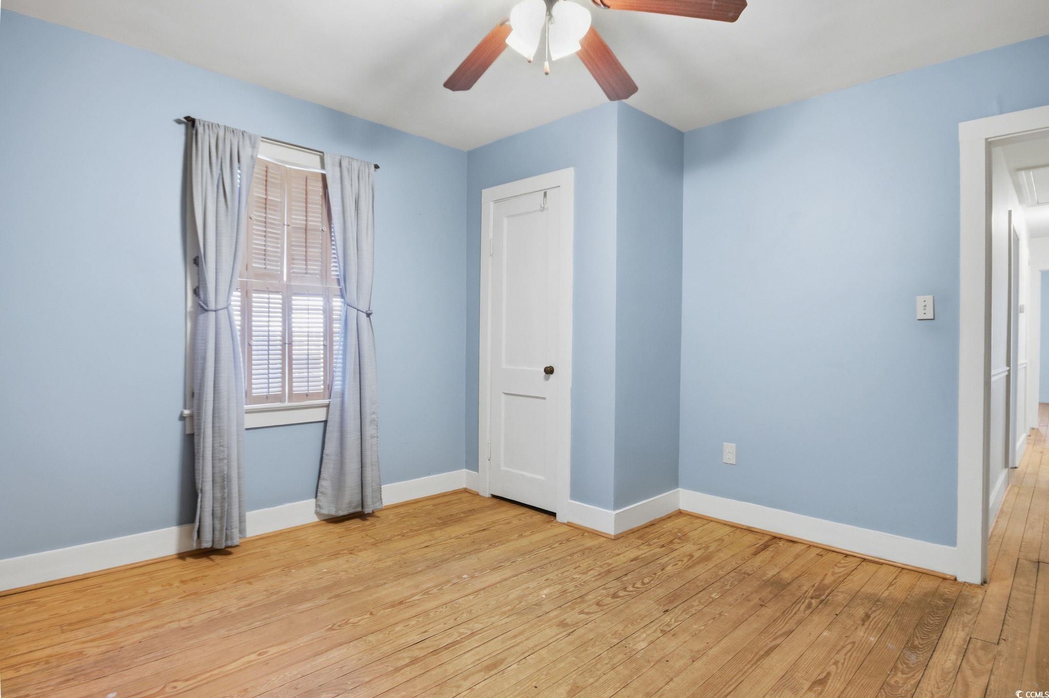 2206 Beck Street Georgetown, SC 29440 - Photo 19 of 36 Unfurnished bedroom featuring light wood-style floors, ceiling fan, and a closet