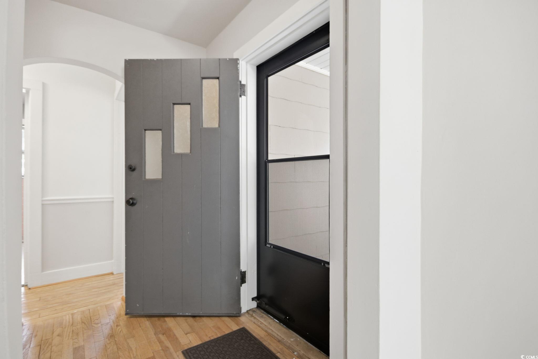 2206 Beck Street Georgetown, SC 29440 - Photo 6 of 36 Doorway to outside featuring wood finished floors and arched walkways