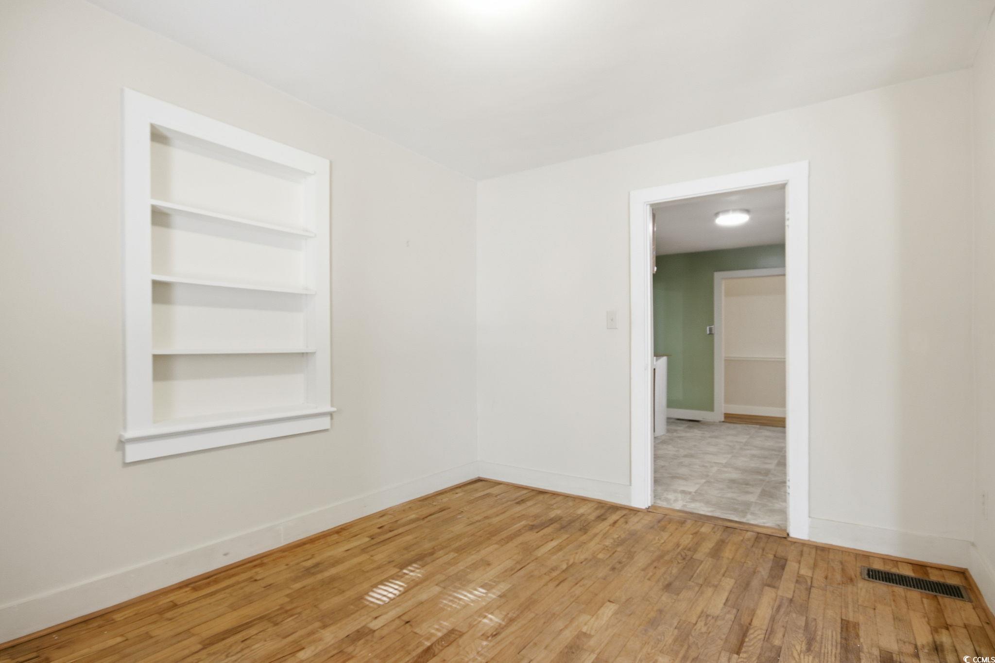 2206 Beck Street Georgetown, SC 29440 - Photo 9 of 36 Unfurnished room with built in features and wood-type flooring