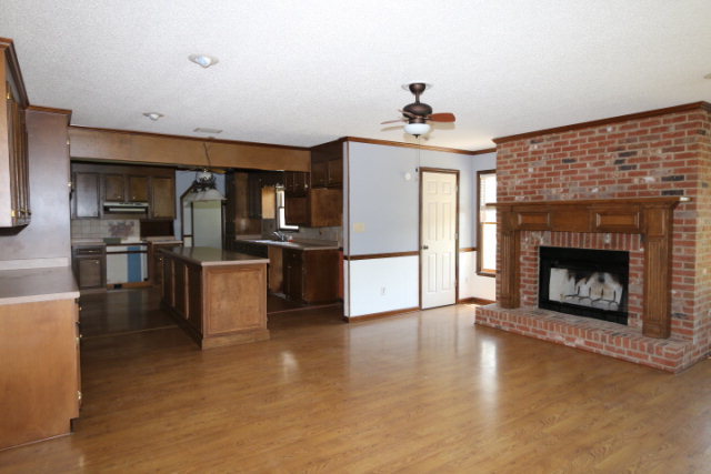 207 J R Boulevard Macon, GA 31220 - Photo 5 of 18 a living room with stainless steel appliances furniture a fireplace and a kitchen view