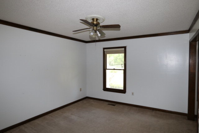 207 J R Boulevard Macon, GA 31220 - Photo 10 of 18 an empty room with windows and fan