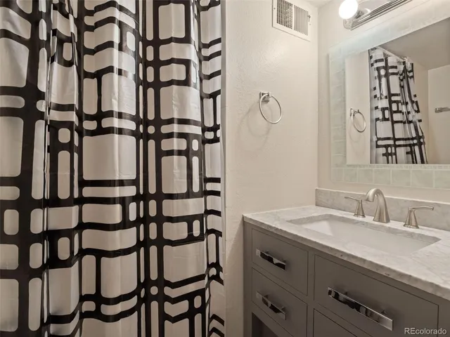 a bathroom with a sink and mirror