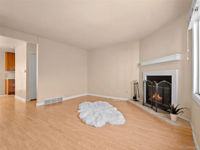 a view of empty room with a fireplace