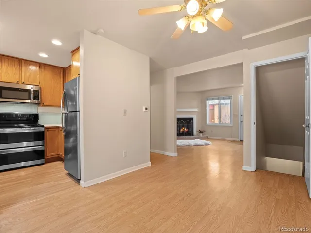 a view of a kitchen with a stove cabinets and a ceiling fan