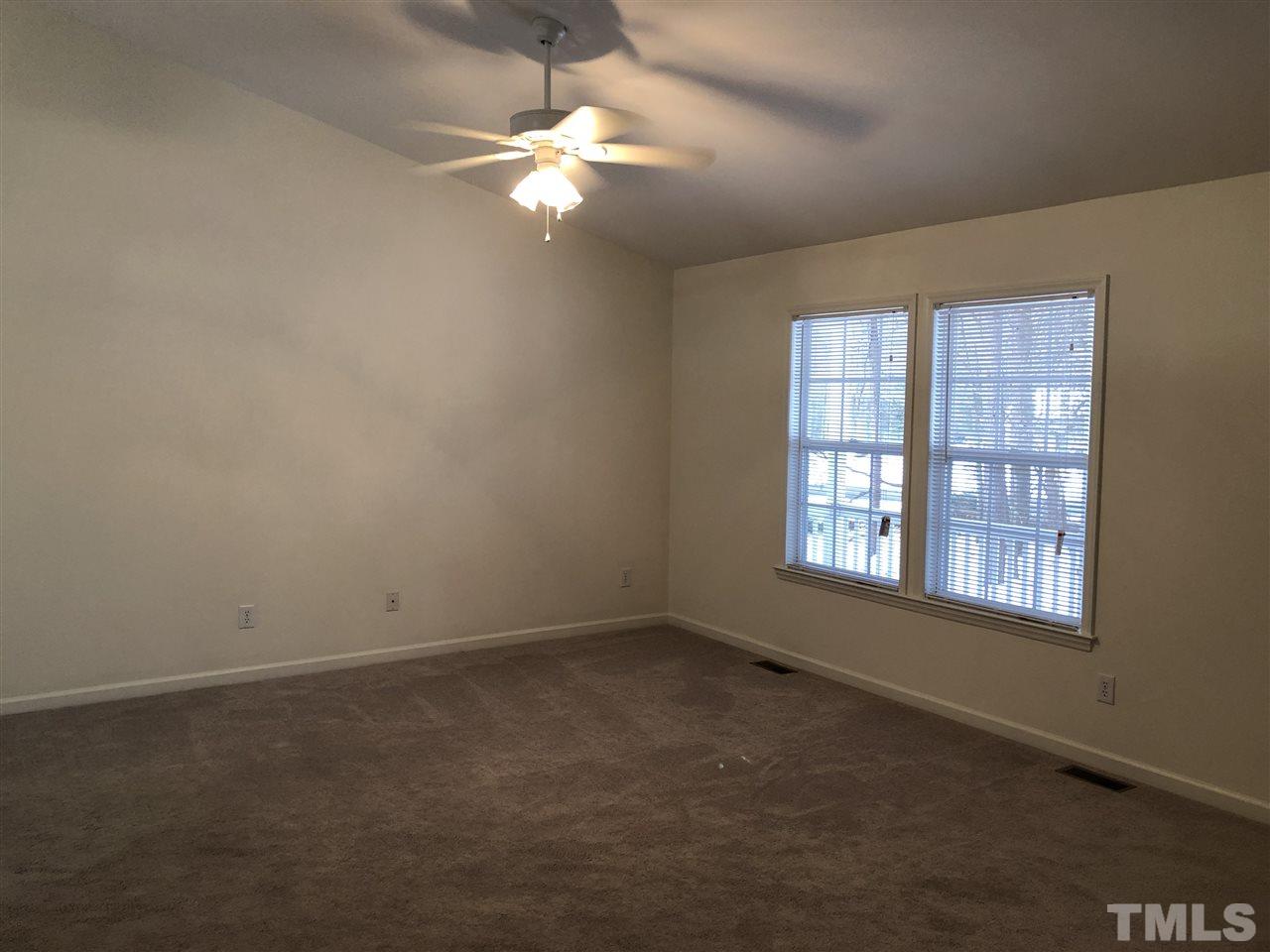 551 Ned Moore Road Timberlake, NC 27583 - Photo 3 of 12 an empty room with windows and fan