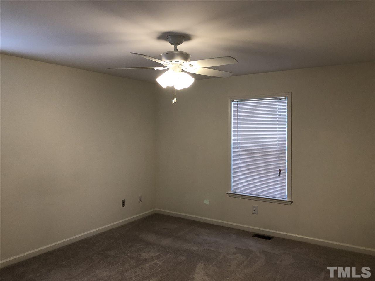 551 Ned Moore Road Timberlake, NC 27583 - Photo 8 of 12 an empty room with a window and a fan