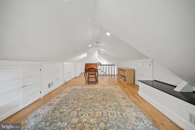 a bedroom with a bed and a bookshelf