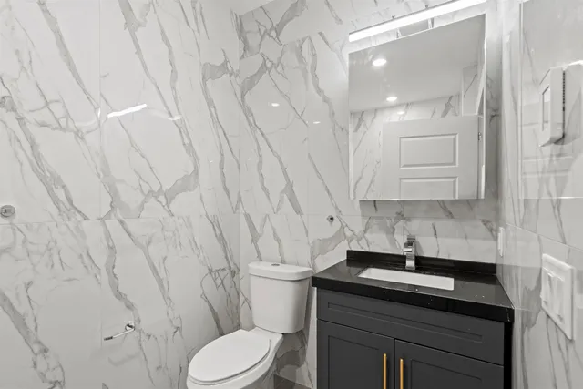 a bathroom with a sink toilet and vanity