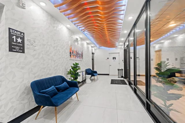 a lobby with furniture and a potted plant