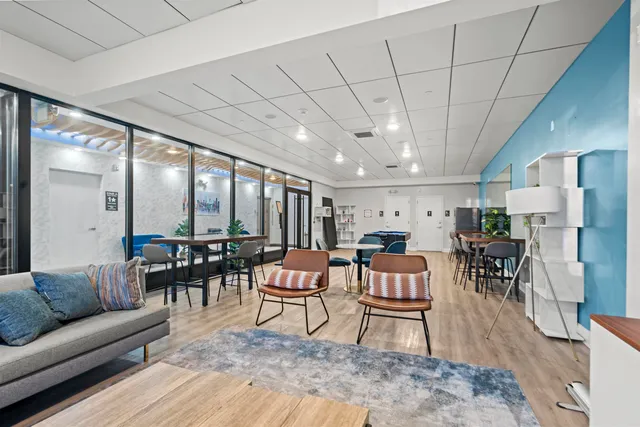 a living room with furniture and a dining table with kitchen view