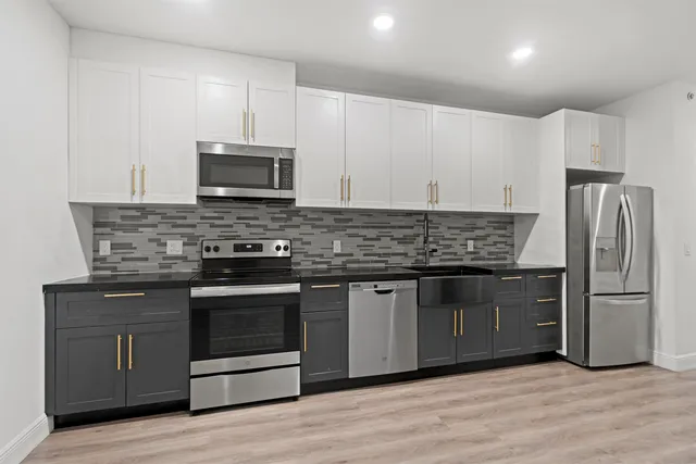 a kitchen with granite countertop wooden cabinets and stainless steel appliances