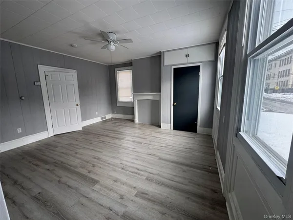 a view of empty room with wooden floor