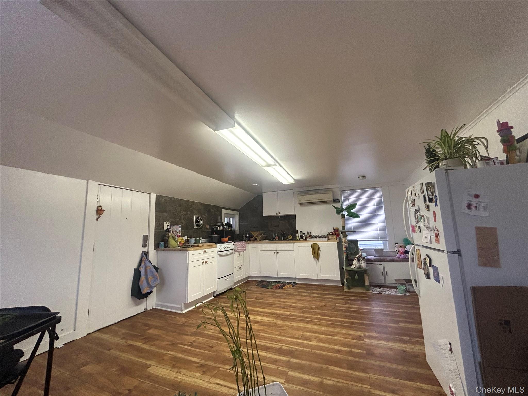 34 Hoffman Street Poughkeepsie, NY 12601 - Photo 6 of 10 a view of a living room kitchen with furniture and wooden floor