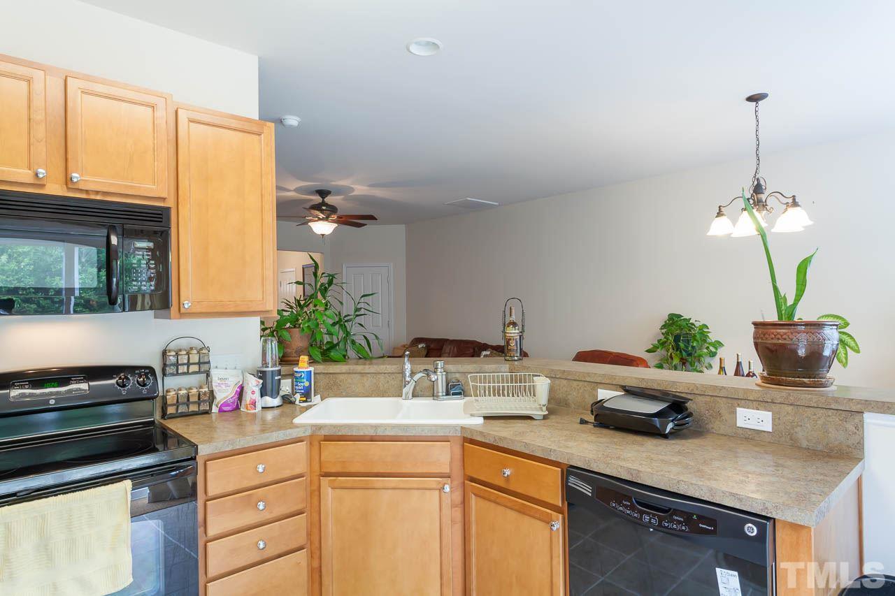 8712 Redcrest Place Raleigh, NC 27617 - Photo 8 of 15 a kitchen with a sink a counter and cabinets