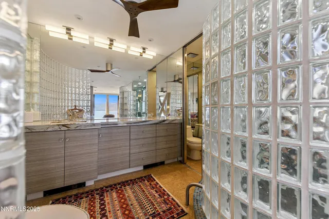 a bathroom with a tub sink shower and mirror