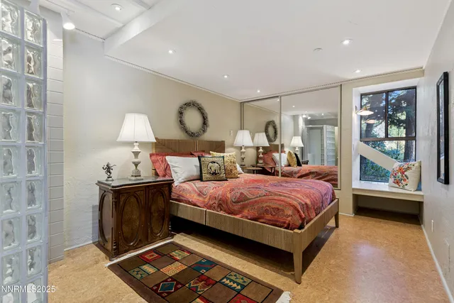 a bedroom with a bed and a lamp