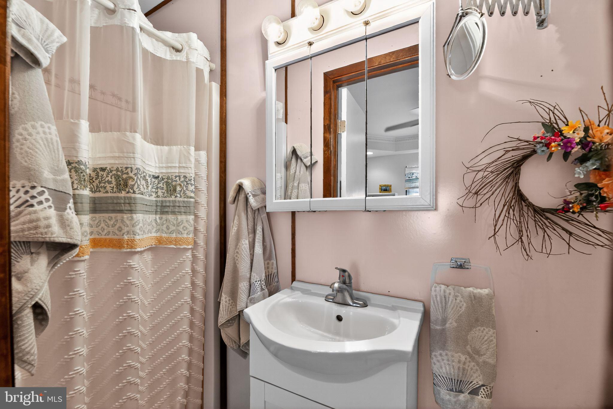 37 Pine Grove Avenue Clementon, NJ 08021 - Photo 19 of 28 a bathroom with a sink and mirror with bathtub