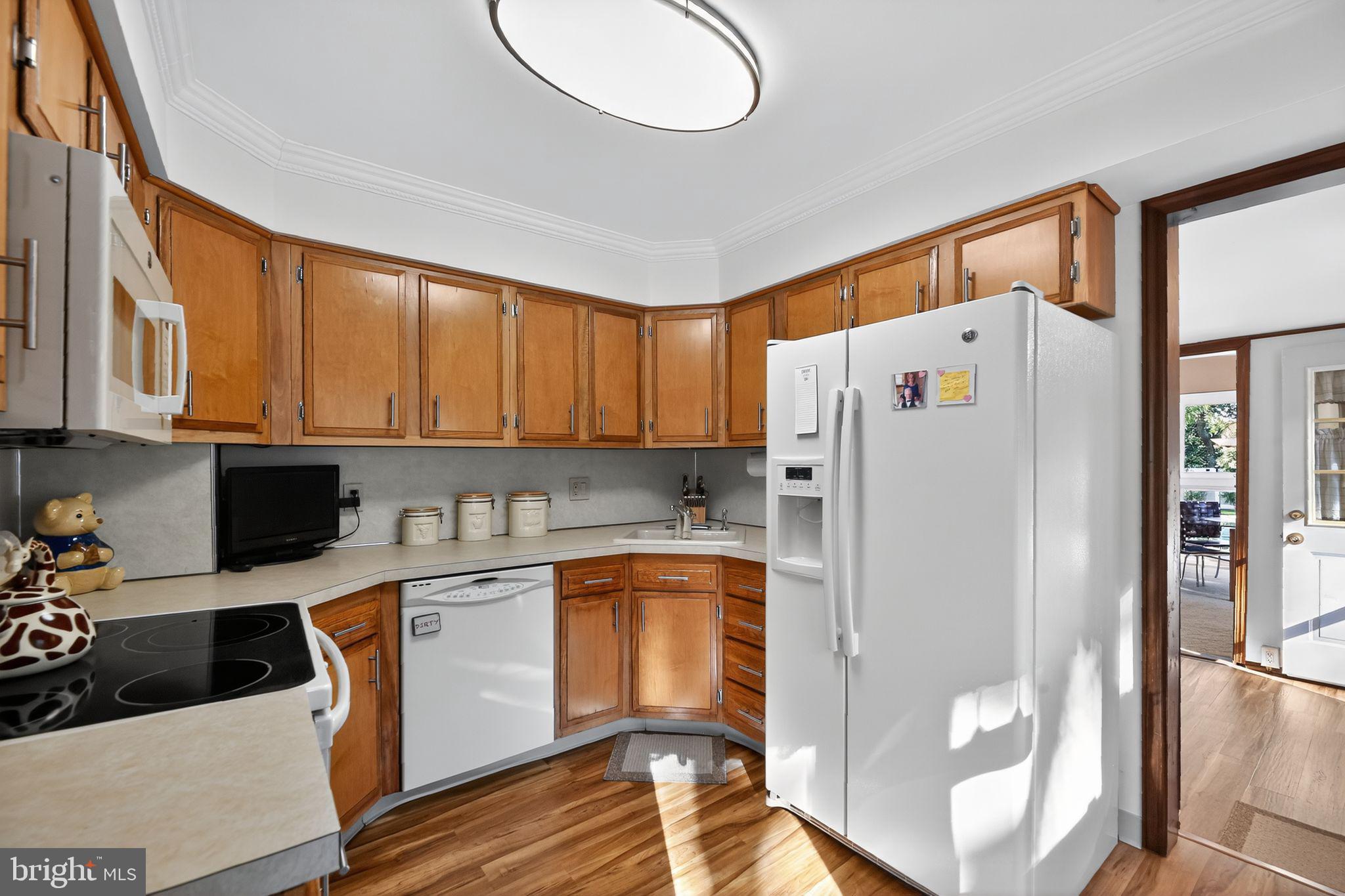37 Pine Grove Avenue Clementon, NJ 08021 - Photo 9 of 28 a kitchen with a refrigerator a sink and cabinets