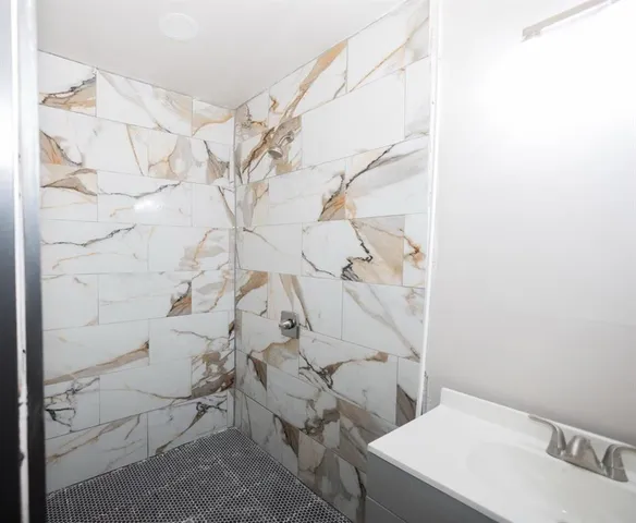 a bathroom with a bathtub and shower