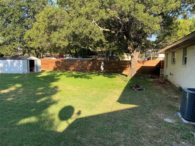 a view of a backyard with swimming pool