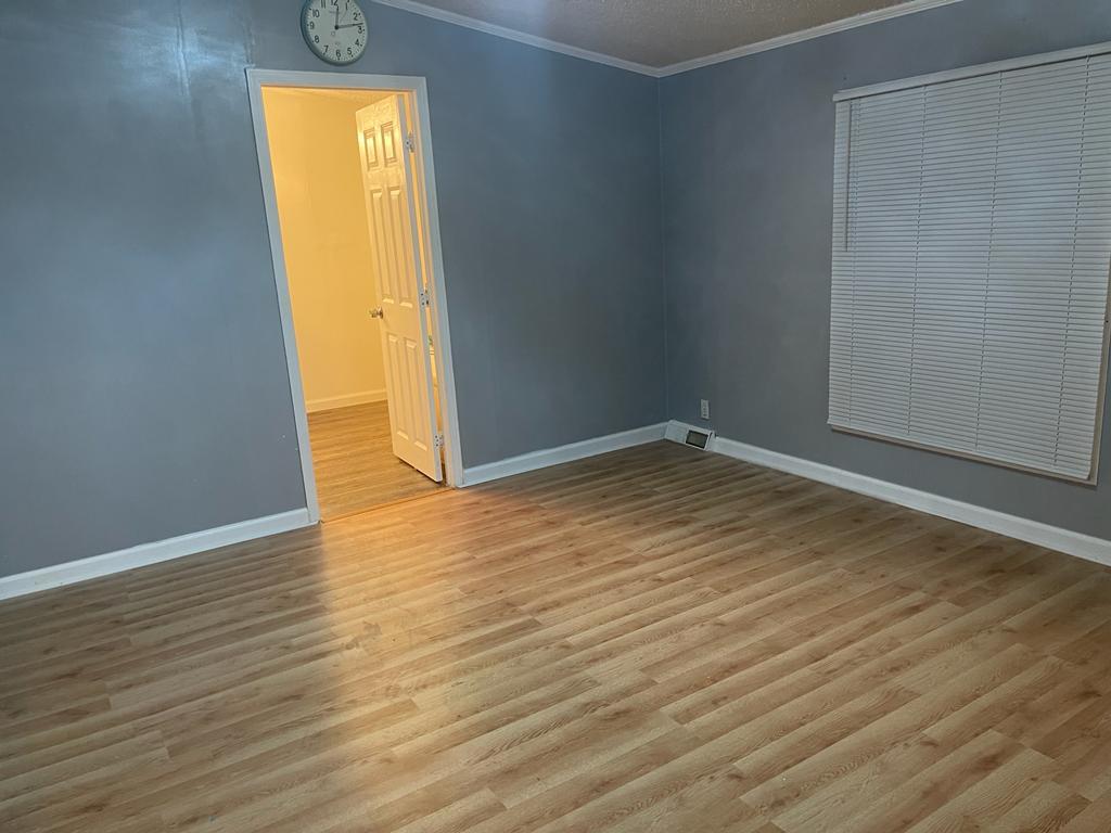 99 Partridge Lane Beecher, IL 60401 - Photo 13 of 22 an empty room with a wooden floor and a window