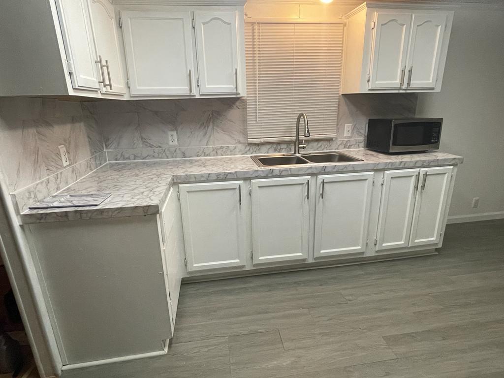 99 Partridge Lane Beecher, IL 60401 - Photo 4 of 22 a kitchen with stainless steel appliances granite countertop a sink and a white cabinets