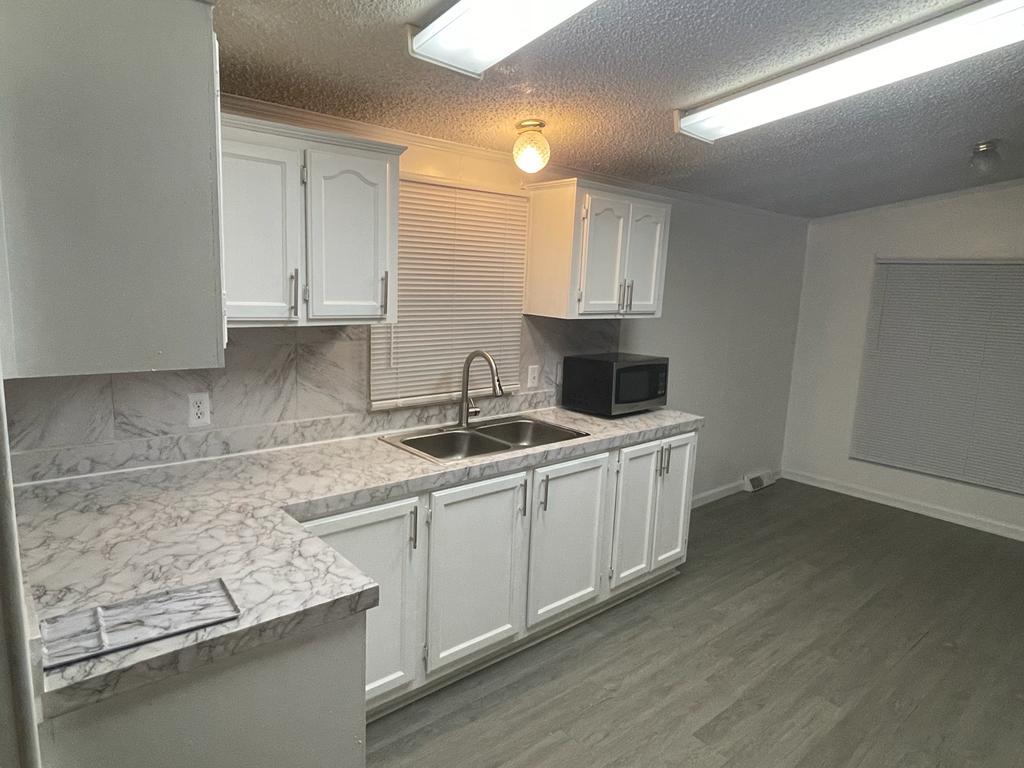 99 Partridge Lane Beecher, IL 60401 - Photo 5 of 22 a kitchen with stainless steel appliances granite countertop a sink stove and cabinets